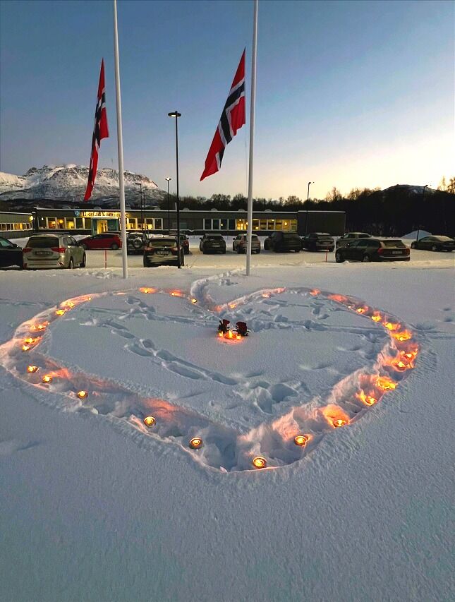 Onsdag ettermiddag lyste levende lys i snøen utenfor kommunehuset i Hamnvik, ilag med to flagg på halv stang, i forbindelse med Ibestad-mannen i 20-årene som er drept i Ukraina.
 Foto: Tiril Høie